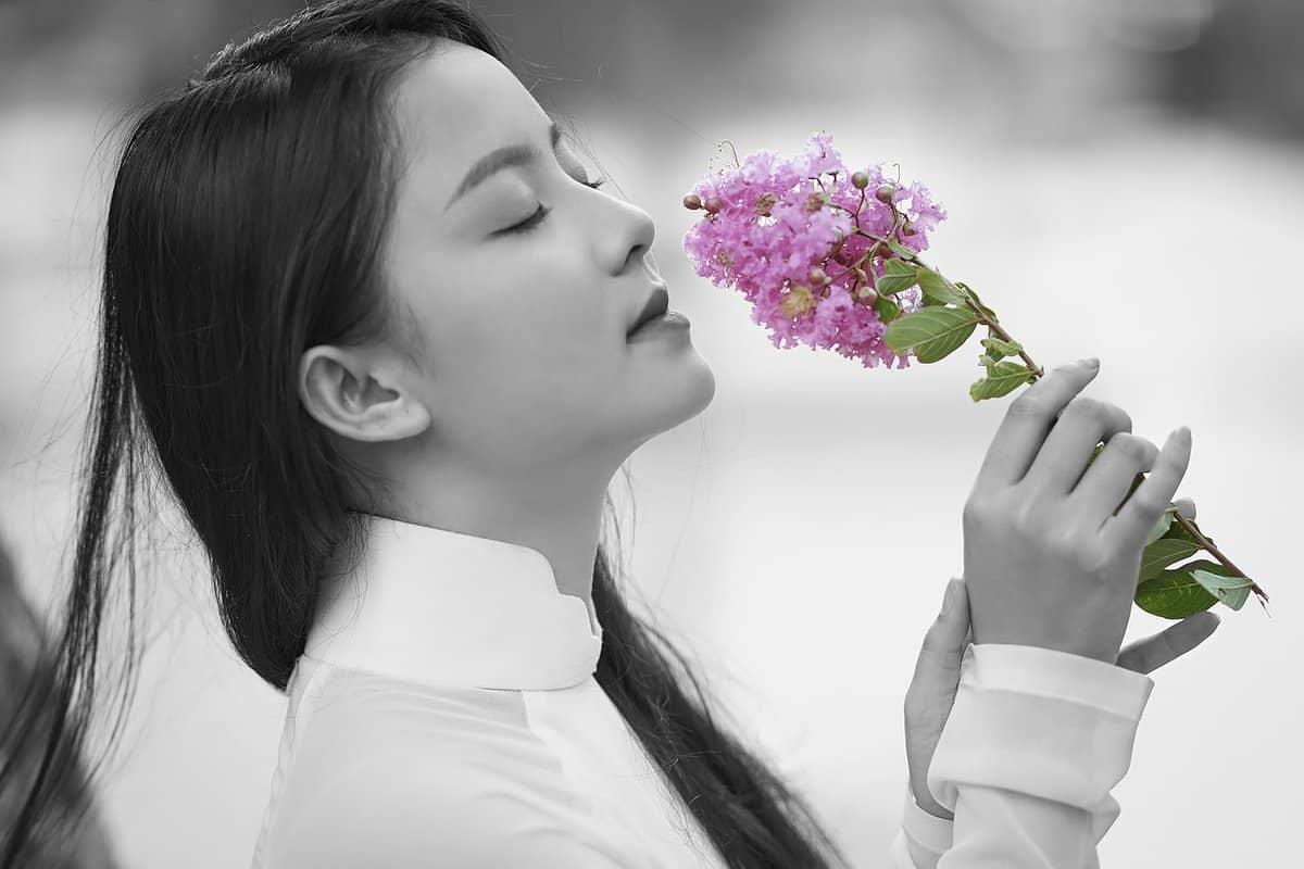 girl-smelling-flower