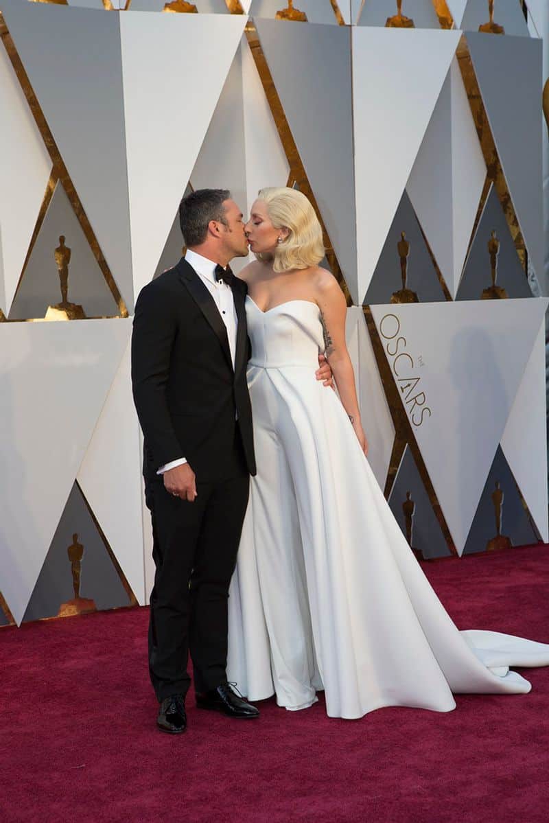 Lady Gaga (Aries) and Taylor Kinney (Cancer): Spotlight Meets Security